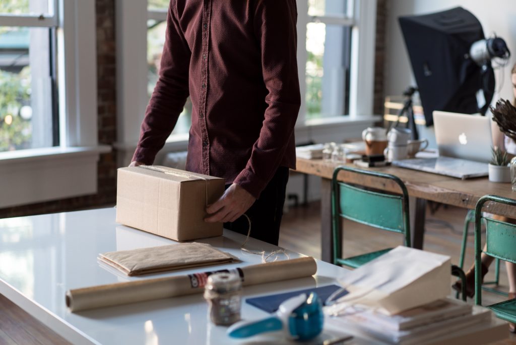 A man with a package on a table