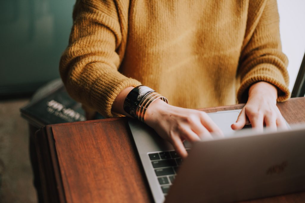 Photo of a person using a laptop for "Should My Website Have a Chatbot?" post.