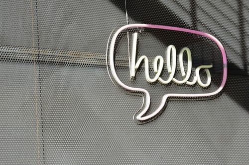 Image of hello cursive text in speech bubble for nonprofit website blog post.